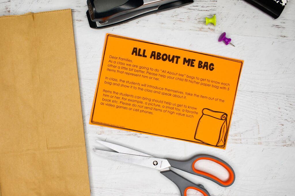 An orange slip of paper next to a paper bag for an All About Me Bag activity